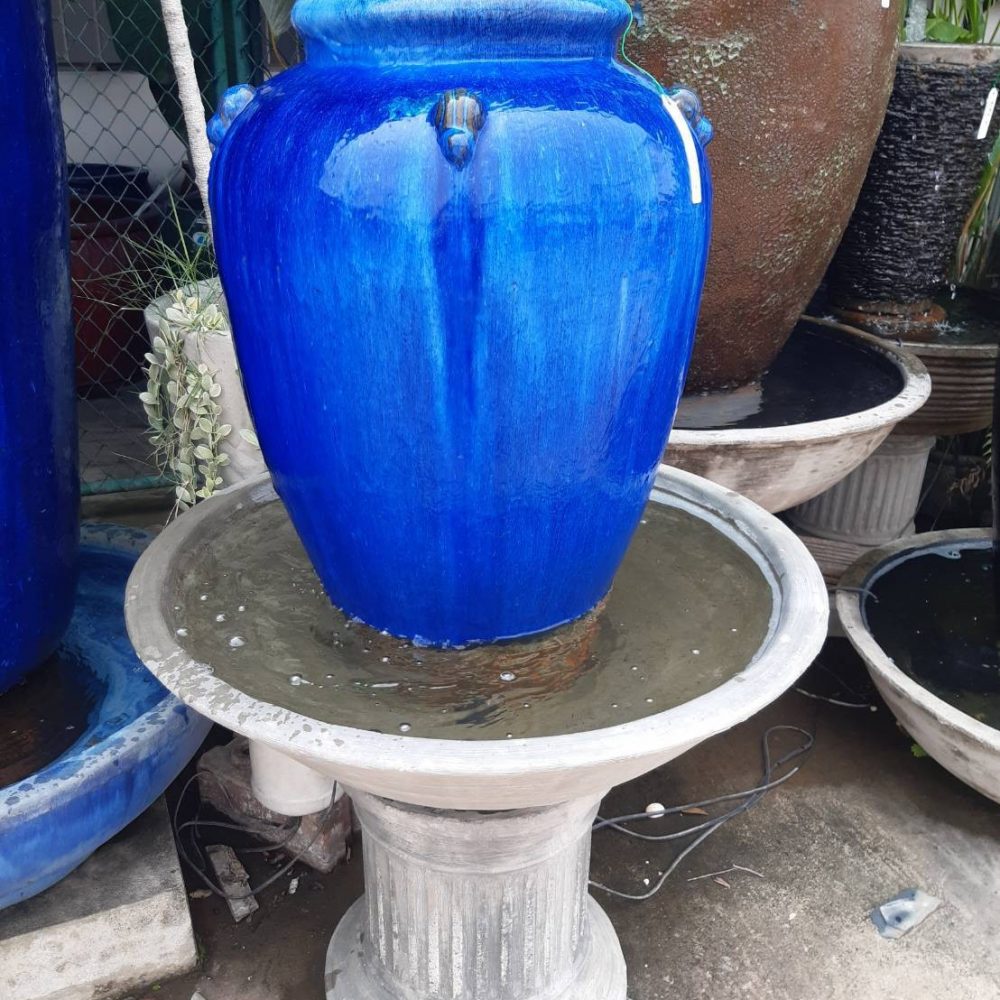 Blue overflowing water jar