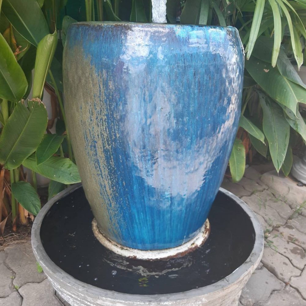 Overflowing water jar bluish blue tone