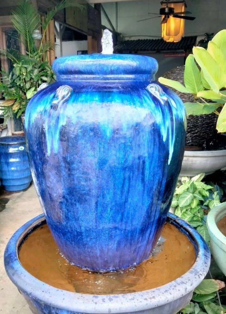 Overflowing water jar aquamarine blue tone