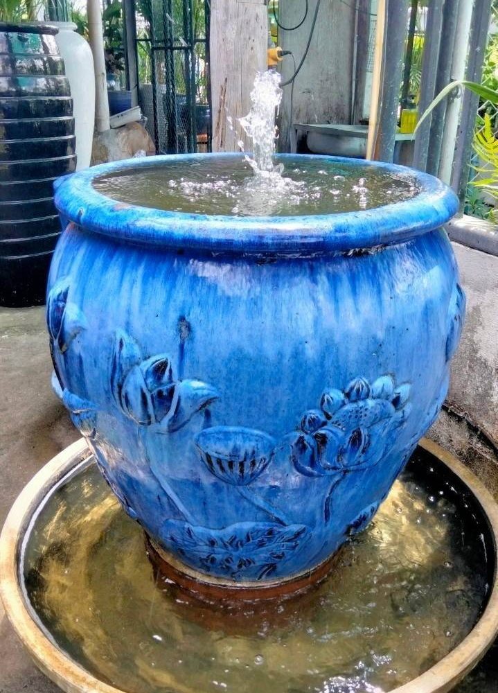 Overflowing water jar green blue tone with lotus pattern