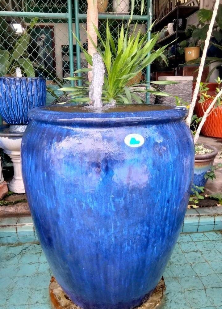 Overflowing water jar in blue tones
