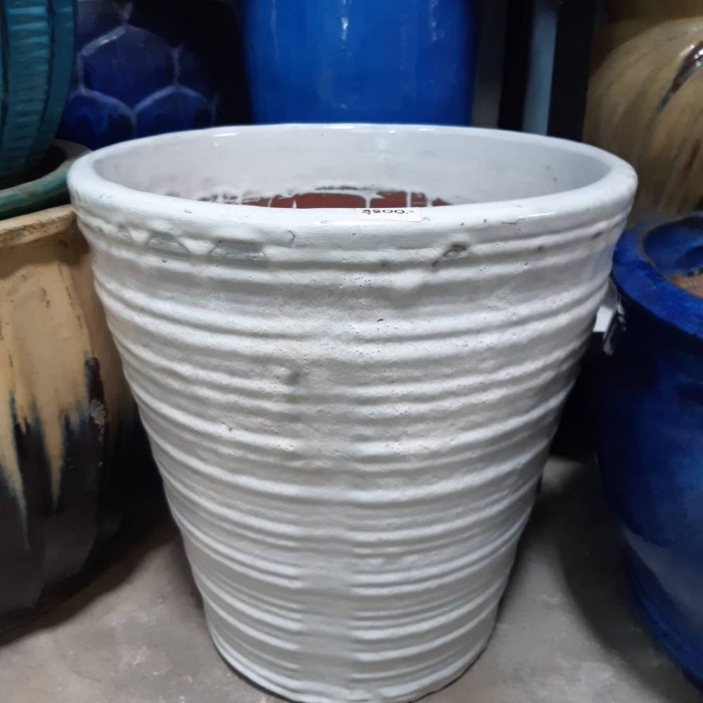 White ceramic planter with stripes in the middle